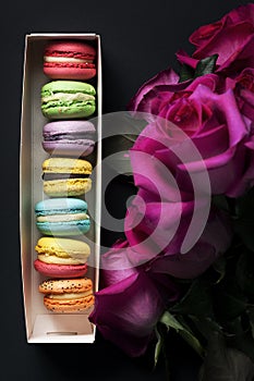 Sweet colorful macaroons and roses