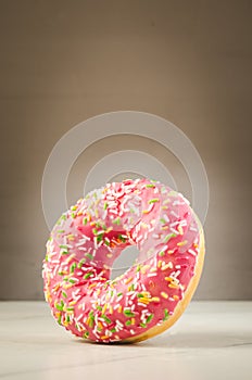 Sweet and colourful doughnut/Sweet and colourful doughnut with falling on a white table