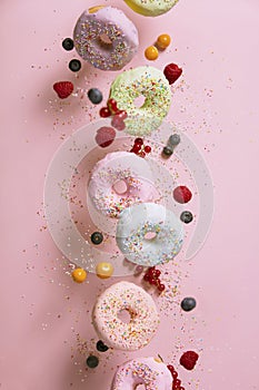 Sweet and colourful doughnuts falling or flying in motion