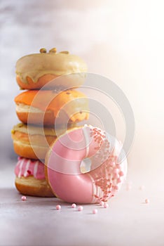 Sweet and colourful doughnuts on grey background. Fresh baked donuts. Copy space.