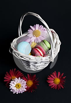 Sweet and colourful french macaroons in the basket