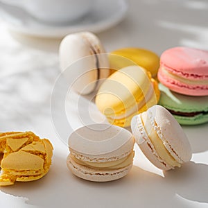 Sweet and colourful french macaroons or macaron on a light background.