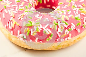 Sweet and colourful pink doughnut/Sweet and colourful pink doughnut on a background. Close up