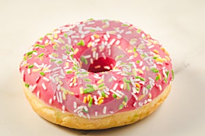 Sweet and colourful pink doughnut/Sweet and colourful pink doughnut on a marble background. Selective focus