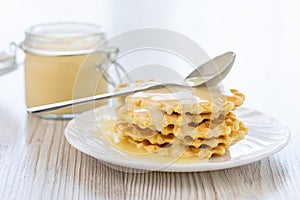Sweet Condensed or evaporated milk and waffles on a table