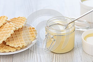 Sweet Condensed or evaporated milk and waffles on a table.
