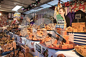 Sweet confection fudge stand stall vendor displaying Irn Bru fudge in market place setting