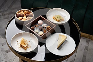 Sweet cookie snack, cake slices and chocolate candy on table, close-up