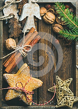 Sweet cookies, wooden angels, decorative golden stars, nuts, cinnamon sticks