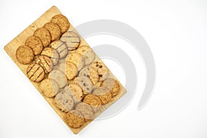 Sweet cookies on wooden cutting board