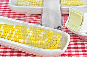 Sweet corn on the cob, buttered and salted in a corn dish