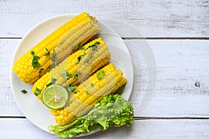 Sweet corn food with salad vegetable lime coriander and lettuce, ripe corn cobs steamed or boiled sweetcorn for food vegan dinner