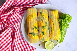 Sweet corn food with salad vegetable lime coriander and lettuce, ripe corn cobs steamed or boiled sweetcorn for food vegan dinner