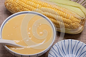 Sweet corn soup in a ceramic cup on wooden background.copy space