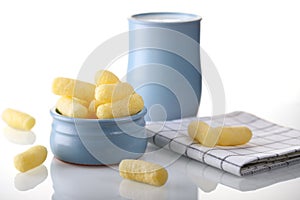 Sweet, corn sticks in a blue plate with a jug of milk, in bright colors