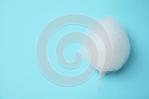 Sweet cotton candy on light blue background, top view.