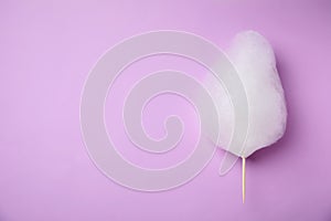 Sweet cotton candy on violet , top view. Space for text