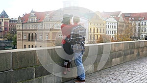 Sweet couple have romantic date while honeymoon trip in old european town. Young lovers kissing and enjoying time