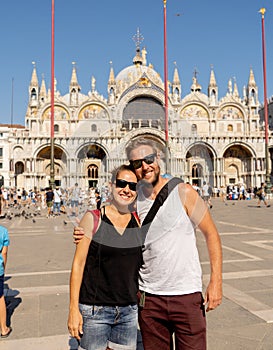 Sweet couple in love taking a selfie in Venice Italy while traveling around europe