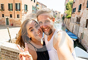 Sweet couple in love taking a selfie in Venice Italy while traveling around europe