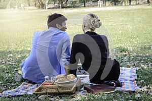 Sweet couple relaxing on picnic in park  young beautiful lover spending time together and having romantic moment in summer garden