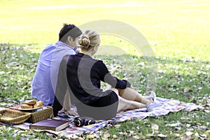 Sweet couple relaxing on picnic in park  young beautiful lover spending time together and having romantic moment in summer garden