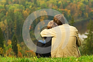 Sweet couple sitting on a hill