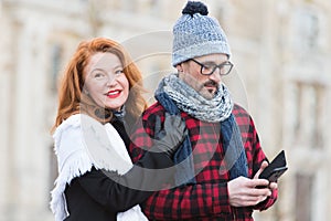 Sweet couple with smart phone in hands. Man with smart-phone in hand and smiled woman.