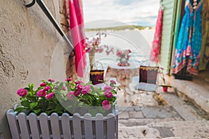 sweet cozy place table at the edge if the beach between building