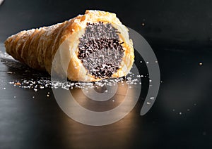 Sweet cream and dark chocolate roll on the table