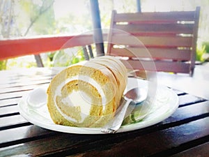 sweet cream roll cake on white dish