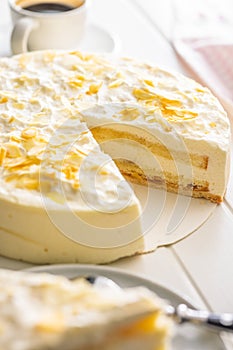 Sweet creamy cake on white table