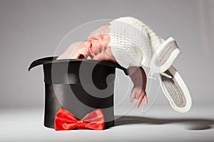 Sweet cute baby in knitted hat with a rabbit ears in the silk hat