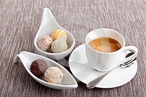 Sweet delicious truffle pralines chocolate and hot espresso coffee