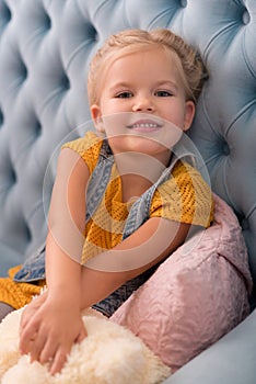 Sweet delighted girl stretching her arms forward