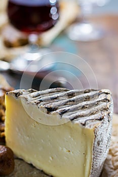 Sweet dessert liqueur wine in glass, hard french cheese Tomme de