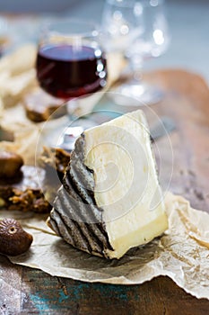 Sweet dessert liqueur wine in glass, hard french cheese Tomme de