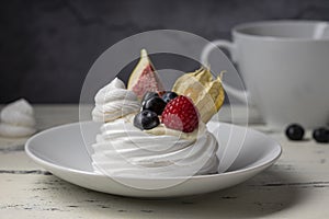 Sweet dessert, Pavlov`s cake with butter cream and raspberry, blueberry, fig