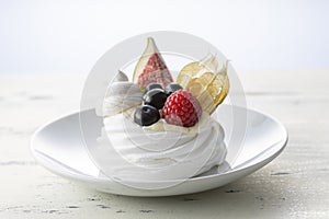 Sweet dessert, Pavlov`s cake with butter cream and raspberry, blueberry, fig