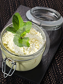 Sweet dessert tiramisu with green tea powder matcha, served in a glass jar