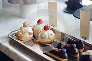 Sweet desserts and cakes in a vitrine of a cafe