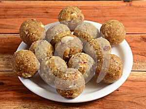 Sweet Dink laddu also known as Dinkache ladoo or gond ke laddoo made using edible gum with dry fruits.served over a white plate on