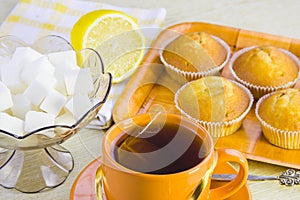 Sweet domestic cakes, tea, lemon and vase with sugar