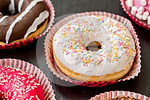 Sweet donuts on the black background