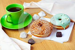 Sweet donuts and cup of black coffee