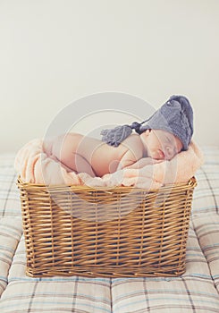 Sweet dream newborn baby in a big basket