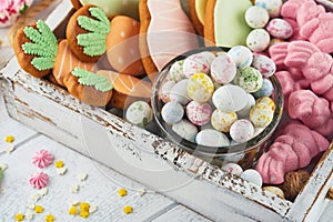 Sweet Easter concept. Sweet Easter kids holiday assortment marshmallows rabbit, chocolates easter eggs, candies, bunny, snacks on