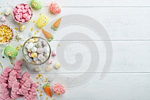 Sweet Easter concept. Sweet Easter kids holiday assortment marshmallows rabbit, chocolates easter eggs, candies, bunny, snacks on