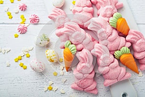 Sweet Easter concept. Sweet Easter kids holiday assortment marshmallows rabbit, chocolates easter eggs, candies, bunny, snacks on