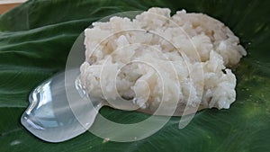 Sweet fermented rice wrapped by Elephant's ear plant leave , dessert in Thai kitchen